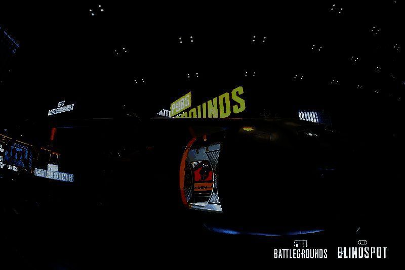 PUBG展台全景图，巨型飞机造型醒目，人群排队等候入场体验