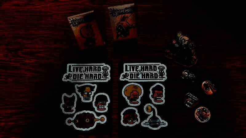 Asobism限量周边展示，包括金属徽章、艺术设定卡和主题贴纸套装