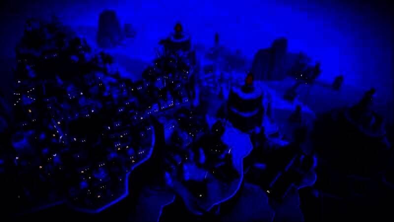 《岛民: 新海岸》游戏界面，岛屿上错落有致地分布着彩色小屋，天空清澈，海面波光粼粼