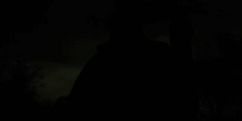 《巫师3》中杰洛特面对艰难抉择的剧情画面，神情凝重，周围环境破败，凸显道德困境的沉重氛围