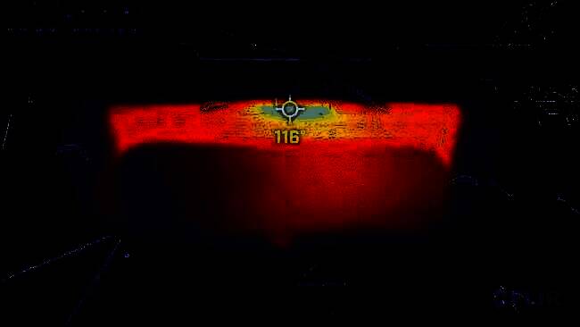 技术人员手持测温仪检测Switch2主机表面温度，屏幕上显示高温警告