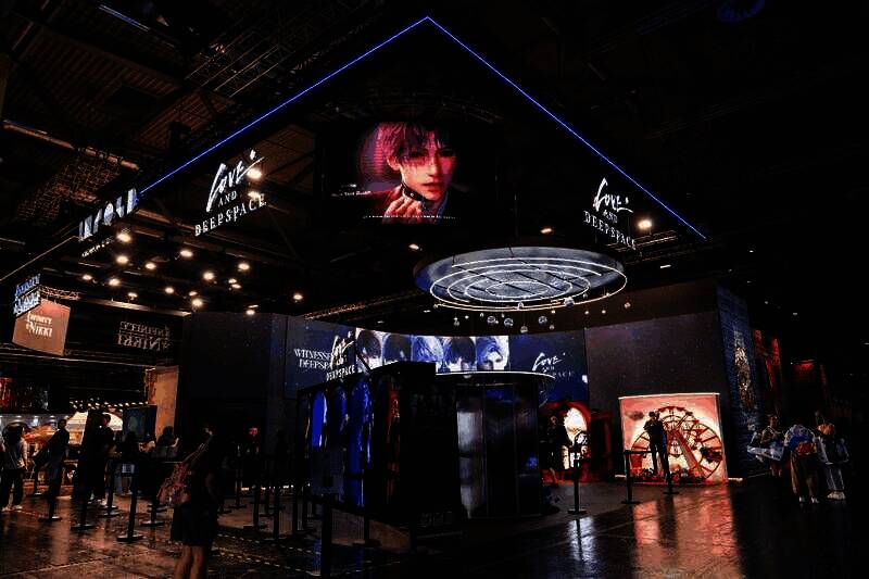 《恋与深空》展台前玩家排队体验温感互动装置，展板上五位男主角角色立绘栩栩如生