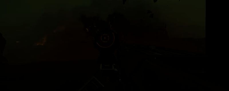 《绝地潜兵2》游戏中一名士兵手持重型机炮在战场上扫射敌人的画面，枪口喷出火光，周围有爆炸特效与敌人倒下的动态场景