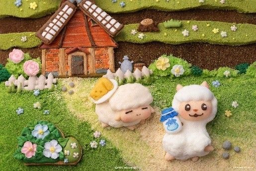 甜品桌布上摆放着牧场风格的纸杯蛋糕和果冻，背景是游戏LOGO装饰