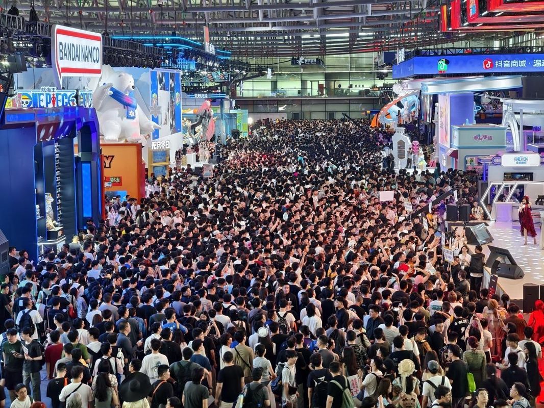 展区内部全景，不同游戏区域风格鲜明，玩家正在体验游戏