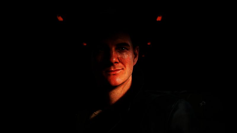 游戏内场景截图，邦德身穿战术装备在昏暗走廊中潜行，手持手枪警戒前方敌人