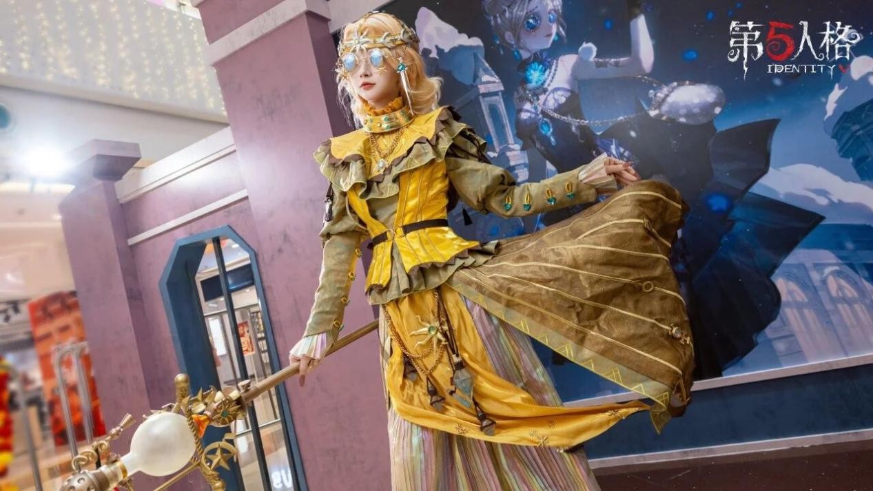 盲女COSER闭目静立于冰晶装饰的「庄园除雪」互动区，手杖轻点地面，周围飘落发光雪花特效